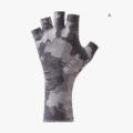 Fingerless fishing gloves resting on a boat gunwale beside a fishing rod