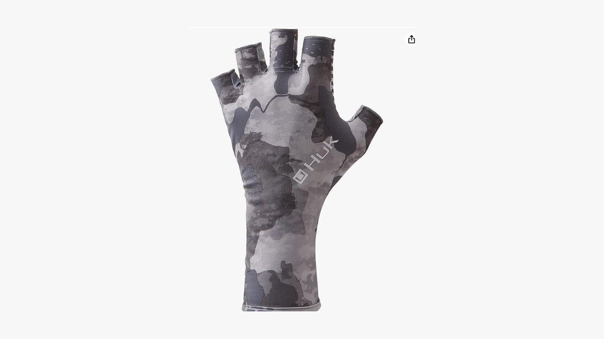Fingerless fishing gloves resting on a boat gunwale beside a fishing rod