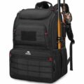Open fishing tackle box backpack on a wooden dock by a calm lake