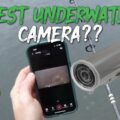Waterproof action camera resting on a fishing boat gunwale at a calm lake